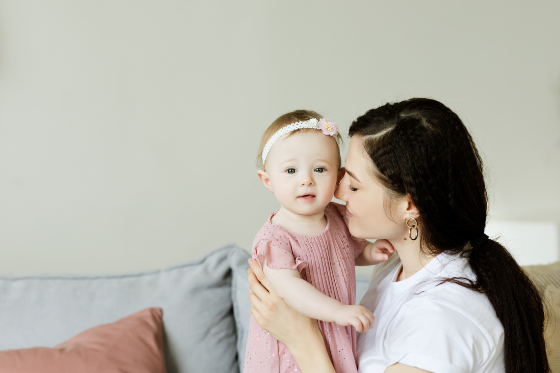 Mother Holding Her Cute Daughter